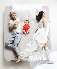 Image showing Top view of happy family with one newborn child in bedroom.