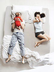 Image showing Top view of happy family with one newborn child in bedroom.