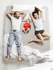 Image showing Top view of happy family with one newborn child in bedroom.