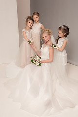 Image showing Little pretty girls with flowers dressed in wedding dresses