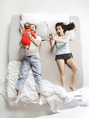 Image showing Top view of happy family with one newborn child in bedroom.