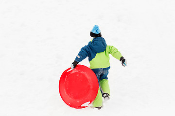 Image showing happy boy with snow saucer sled in winter