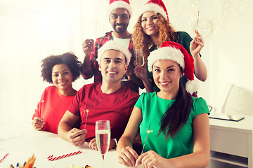 Image showing happy team celebrating christmas at office party