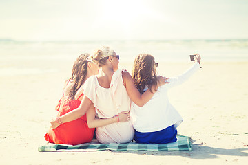 Image showing happy women taking selfie by smartphone on beach