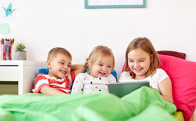 Image showing little kids with tablet pc in bed at home