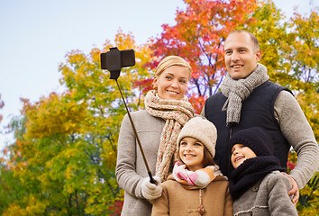 Image showing family taking selfie over autumn park background
