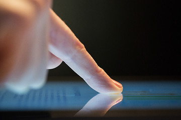 Image showing close up of hand using computer touch screen