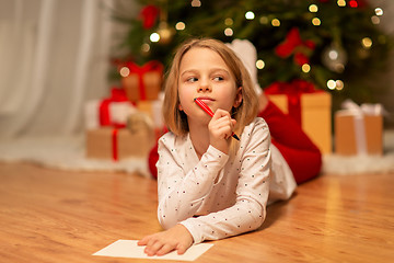 Image showing girl writing christmas wish list at home