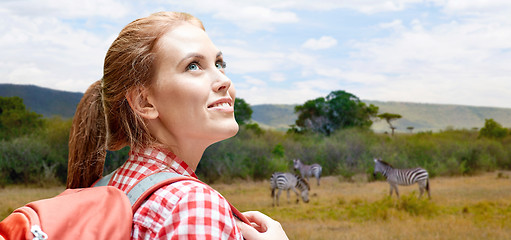 Image showing happy woman with backpack over african savannah