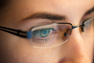 Image showing close up of woman in glasses looking at screen