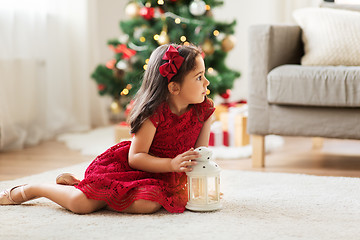 Image showing little girl with lantern at home on christmas