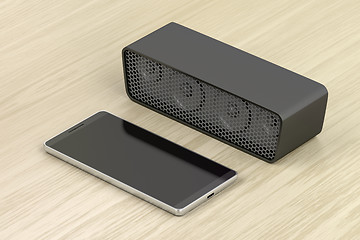 Image showing Black smartphone and bluetooth speaker