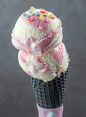 Image showing Ice cream balls in black waffle cone