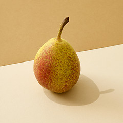 Image showing fresh pear on colored paper background