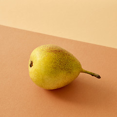 Image showing fresh pear on colored paper background