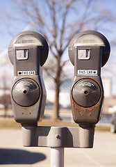 Image showing Old Rusted Parking Meters Still in Service Urban Streets