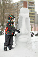 Image showing Boy making a winter snowman