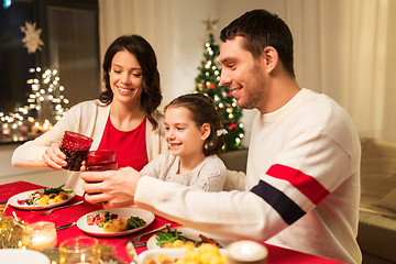 Image showing happy family having christmas dinner at home