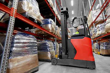 Image showing male loader operating forklift at warehouse