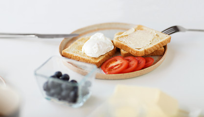 Image showing toasts with poached egg and vegetables on plate