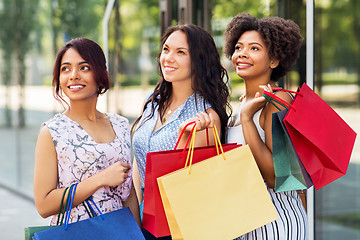 Image showing happy women with shopping bags in city