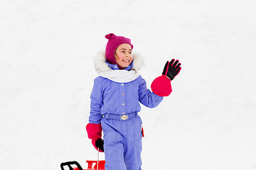 Image showing happy little girl waving hand outdoor in winter