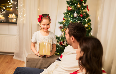 Image showing happy family with christmas present at home