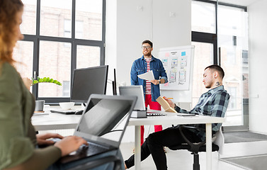 Image showing creative man showing user interface at office