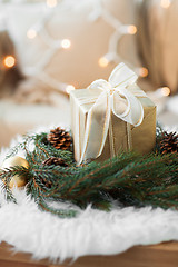 Image showing christmas gift and fir wreath with cones and balls