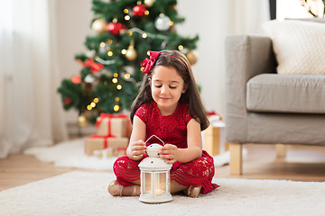 Image showing little girl with lantern at home on christmas