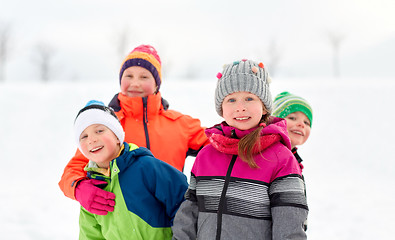 Image showing happy little kids in winter clothes outdoors