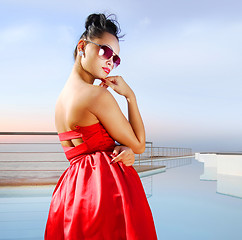 Image showing brunette near the pool in expensive hotel