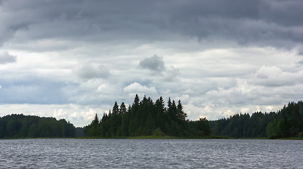 Image showing Dynamic Cloudy Sky Over A Forest Lake