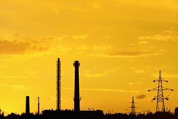 Image showing Industrial landscape with silhouettes of pipes and towers agains