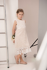 Image showing Little pretty girl with flowers dressed in wedding dresses