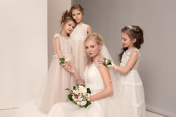 Image showing Little pretty girls with flowers dressed in wedding dresses