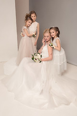 Image showing Little pretty girls with flowers dressed in wedding dresses