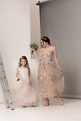 Image showing Little pretty girls with flowers dressed in wedding dresses