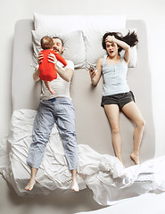 Image showing Top view of happy family with one newborn child in bedroom.