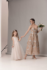 Image showing Little pretty girls with flowers dressed in wedding dresses