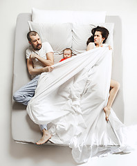 Image showing Top view of happy family with one newborn child in bedroom.