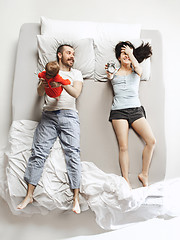 Image showing Top view of happy family with one newborn child in bedroom.