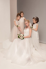 Image showing Little pretty girls with flowers dressed in wedding dresses