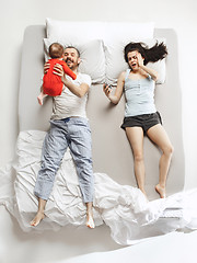 Image showing Top view of happy family with one newborn child in bedroom.