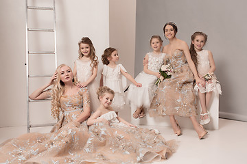 Image showing Little pretty girls with flowers dressed in wedding dresses