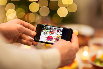 Image showing hands photographing food at christmas dinner