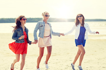 Image showing group of smiling women in sunglasses on beach