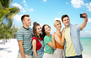 Image showing friends taking selfie by smartphone over beach