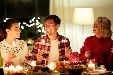 Image showing happy friends celebrating christmas at home feast