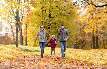 Image showing happy family walking at autumn park